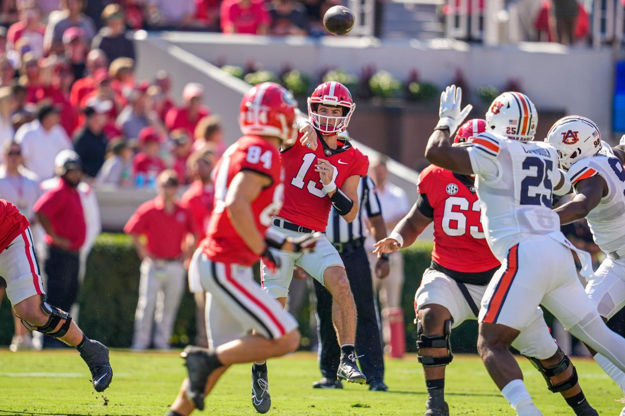 Oct 8, 2022; Athens, Georgia, USA; Georgia Bulldogs quarterback Stetson Bennett (13) passes the ball to wide receiver Ladd McConkey (84) against the Auburn Tigers during the first quarter at Sanford Stadium. Dale Zanine-USA TODAY Sports