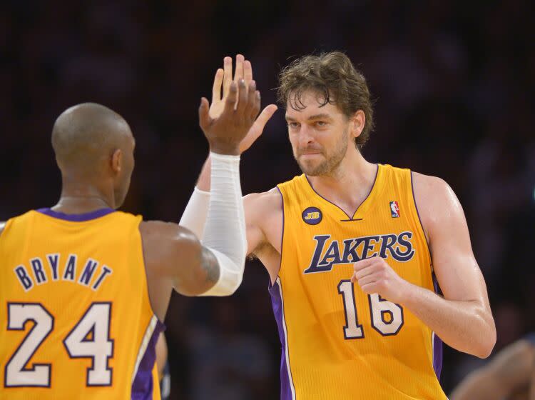 Los Angeles Lakers guard Kobe Bryant, left, is congratulated by forward Pau Gasol.