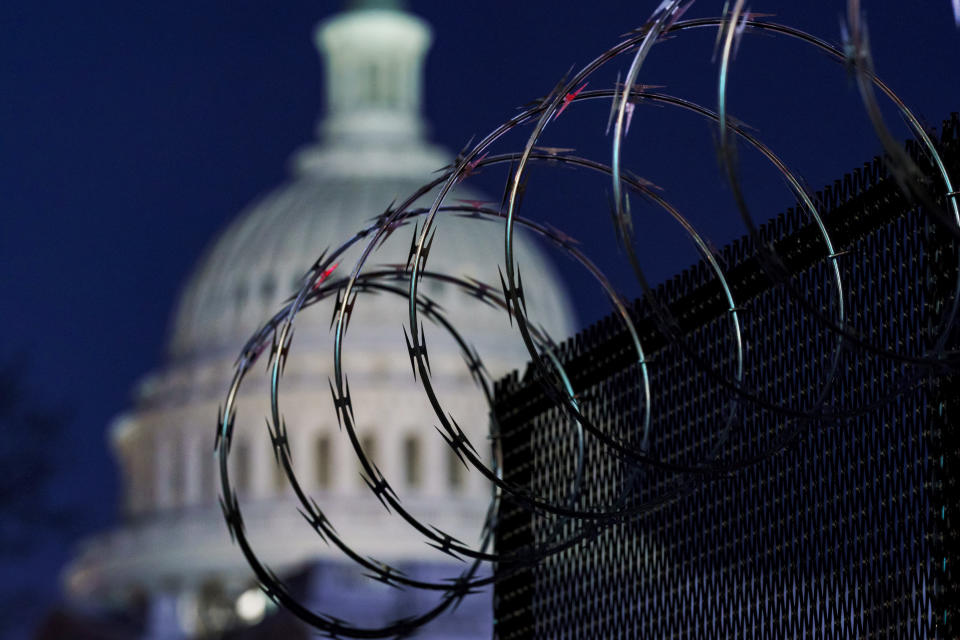 In this Jan. 19, 2021 photo, riot fencing and razor wire reinforce the security zone on Capitol Hill in Washington. The Capitol Police say they are stepping up security at Washington-area transportation hubs and taking other steps to bolster travel security for lawmakers. The moves come as Congress continues to react to this month's deadly assault on the Capitol. (AP Photo/J. Scott Applewhite)