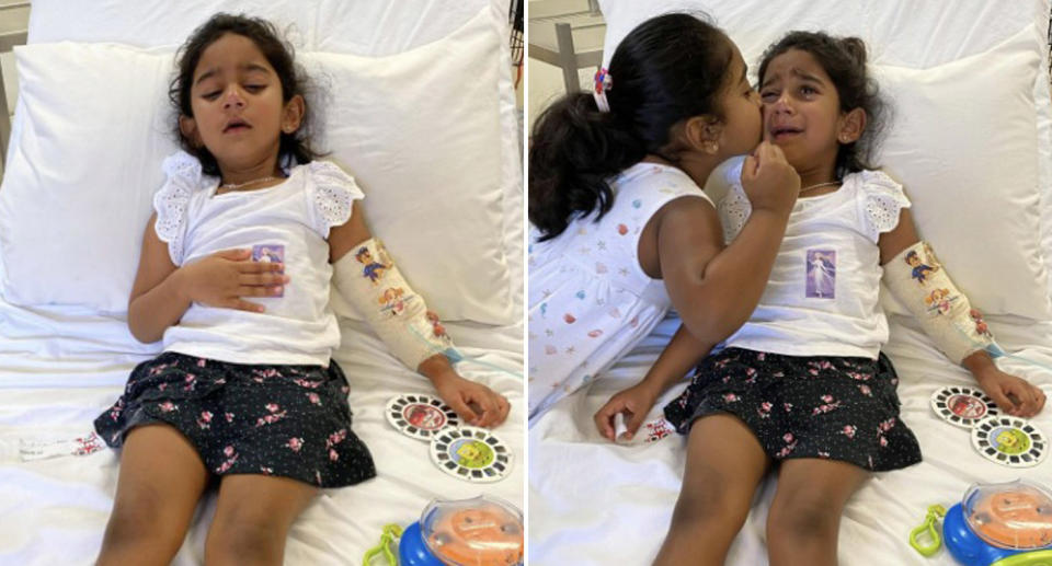 Tharnicaa Murugappan, 3, pictured with her sister Kopika in a hospital bed.