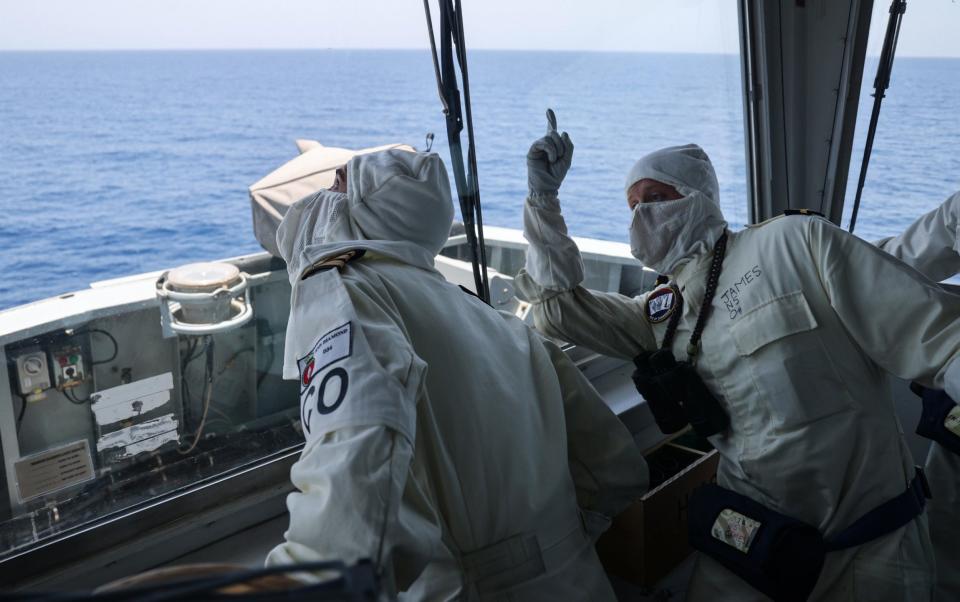 MS Diamond's Commanding Officer, Commander Evans RN and Sub Lt James look at the missile impact smoke in the sky