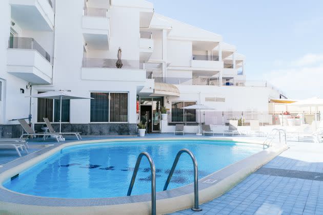 Terrace with swimming pool and sunbeds in a Mediterranean hotel on a sunny day