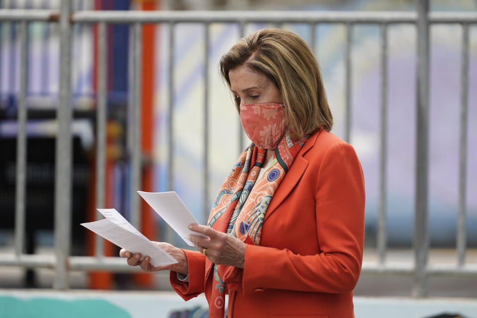 House Speaker Nancy Pelosi looks over her notes before speaking at a news conference at the Mission Education Center Elementary School, Wednesday, Sept. 2, 2020, in San Francisco. Pelosi said she takes responsibility for trusting the word of a San Francisco hair salon she's visited over the years when it told her it was OK to come in for a solo visit this week, even though the city still does not allow indoor beauty services. (AP Photo/Eric Risberg)