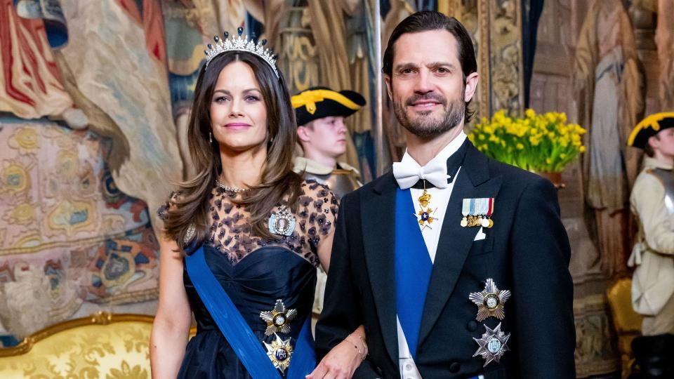 Princess Sofia in navy gown arriving at banquet with Prince Carl Philip