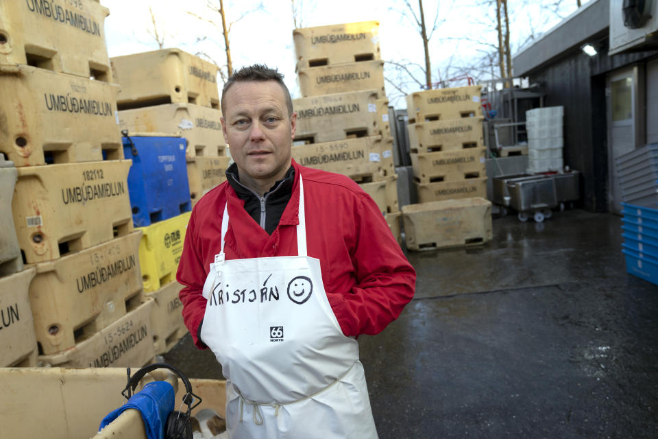 In this photo taken Monday Oct. 28, 2019, fishmonger Kristjan Asgeirsson is seen at work in Reykjavik, Iceland. Asgeirsson lost $68,000 in an online scam. The people of Iceland, who speak a unique dialect of Old Norse, are no longer protected from online fraud because of their linguistic isolation. Modern computer programs, sophisticated auto-translation systems and increased procession speed, has made residents much more vulnerable to computer scams. Recent scams have amounted to the largest thefts the island nation has ever seen. (AP Photo/Egill Bjarnason)