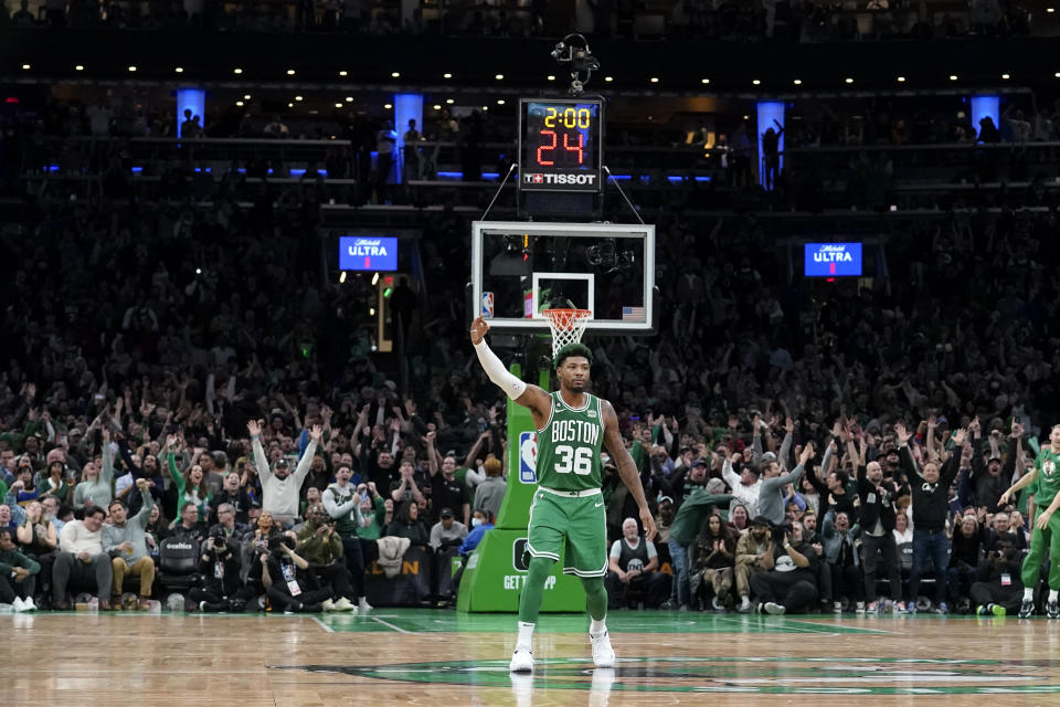 Boston Celtics guard Marcus Smart (36) celebrates after the team scored in overtime in an NBA basketball game against the Golden State Warriors, Thursday, Jan. 19, 2023, in Boston. (AP Photo/Steven Senne)