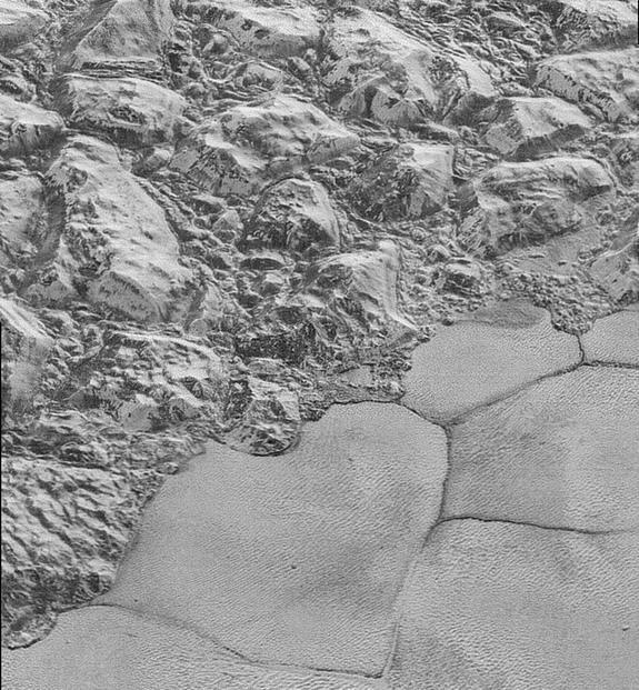 This highest-resolution image from NASA's New Horizons spacecraft shows great blocks of Pluto's water-ice crust which appear jammed together in the informally named al-Idrisi mountains. Image released Dec. 4, 2015.