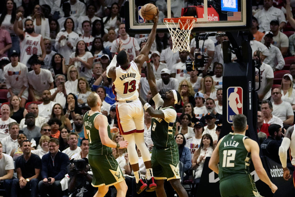 Miami Heat center Bam Adebayo (13) goes to the basket as Milwaukee Bucks guard Joe Ingles (7) and forward Bobby Portis (9) defend during the second half of Game 3 in a first-round NBA basketball playoff series, Saturday, April 22, 2023, in Miami. (AP Photo/Lynne Sladky)