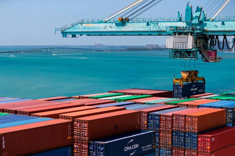 A longshoreman operates a gantry to offload containers from a docked cargo ship at PortMiami on Saturday, February 20, 2021.