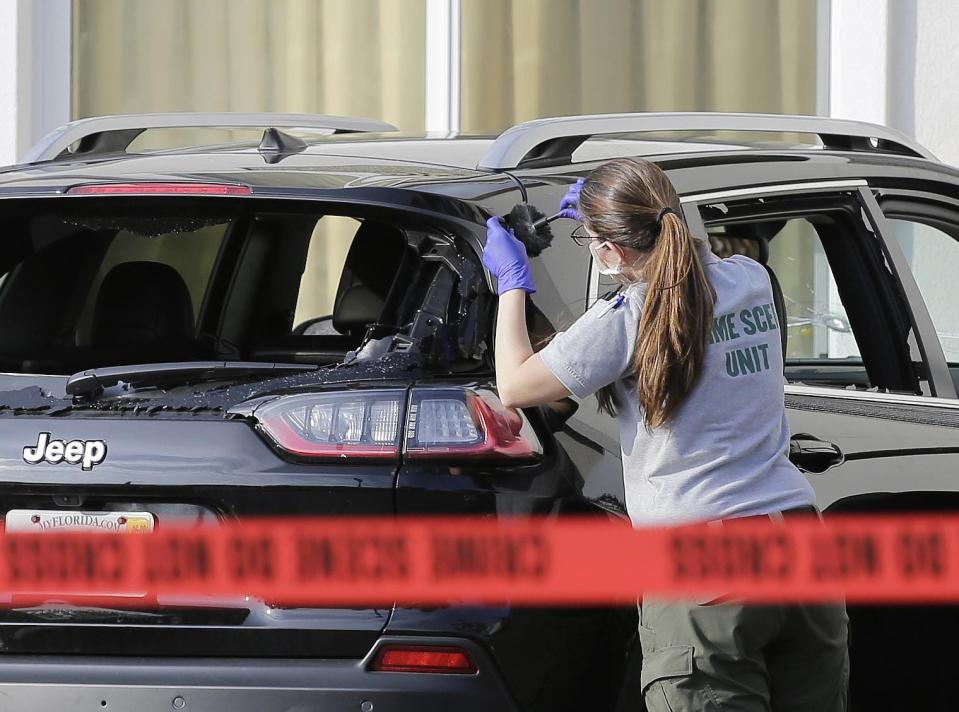 A forensic technician works on the vehicle authorities say officers shot at after the driver, later identified as Hannah Roemhild, breached security at Mar-a-Lago on Jan. 31, 2020.