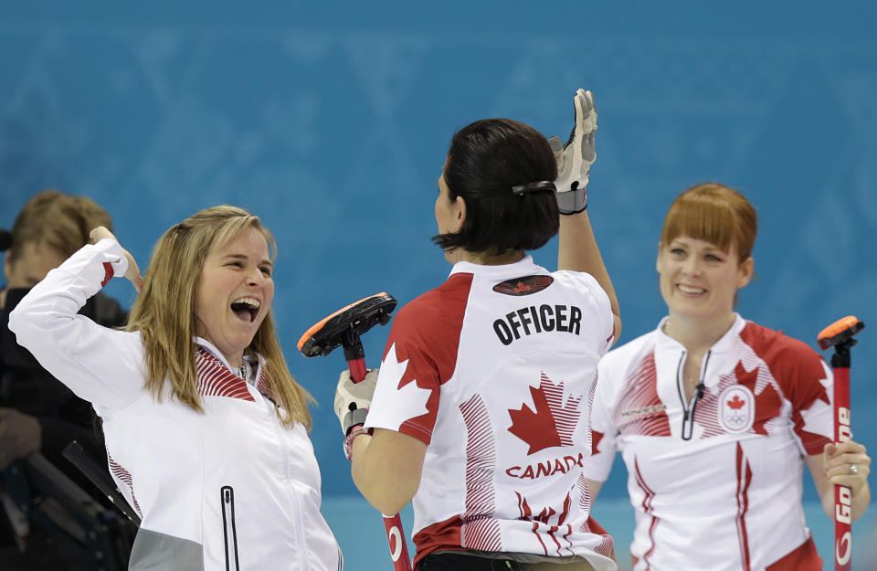 Canada's Jennifer Jones, left, celebrates with Jill Officer, center and Dawn McEwen, right, after beating Britain in the women's curling semifinal game at the 2014 Winter Olympics, Wednesday, Feb. 19, 2014, in Sochi, Russia. (AP Photo/Wong Maye-E)