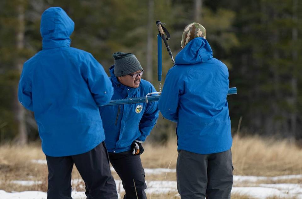 Sean de Guzman, center, snow survey manager at the Department of Water Resources, conducts the first snow survey of the season with his team at Phillips Station in El Dorado County on Tuesday.