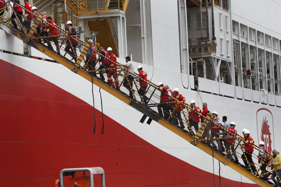 Members of the press and officials on a tour, board the drilling ship 'Yavuz' scheduled to be dispatched to the Mediterranean, at the port of Dilovasi,outside Istanbul, Thursday, June 20, 2019. Turkish officials say the drillship Yavuz will be dispatched to an area off Cyprus to drill for gas. The Cyprus government says Turkey’s actions contravene international law and violate Cypriot sovereign rights. (AP Photo/Lefteris Pitarakis)