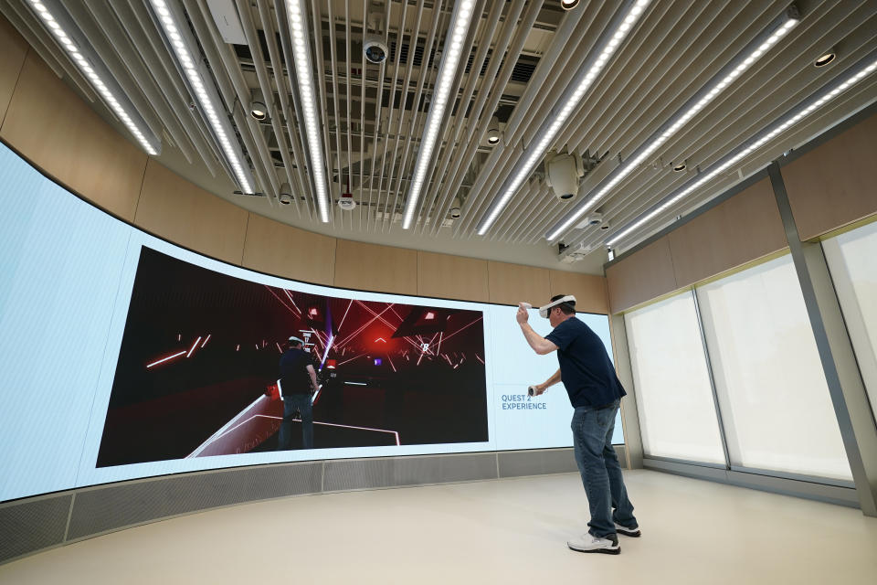 A man experiences the Quest 2 virtual headset during a preview of the Meta Store in Burlingame, Calif., Wednesday, May 4, 2022. (AP Photo/Eric Risberg)