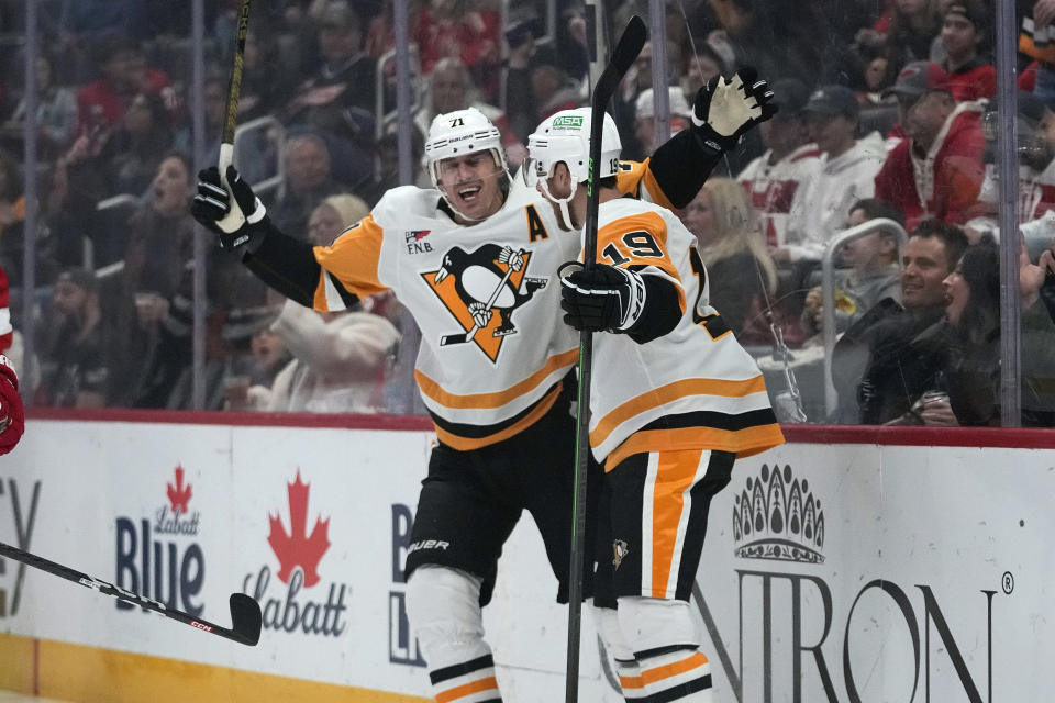 Pittsburgh Penguins center Evgeni Malkin (71) celebrates his goal against the Detroit Red Wings with Reilly Smith (19) in the first period of an NHL hockey game Wednesday, Oct. 18, 2023, in Detroit. (AP Photo/Paul Sancya)