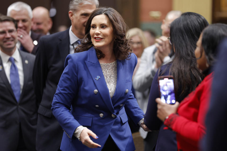 Michigan Gov. Gretchen Whitmer greets legislators and guests as she makes her way through the House chambers before delivering her State of the State address to a joint session of the House and Senate, Wednesday, Jan. 24, 2024, at the state Capitol in Lansing, Mich. (AP Photo/Al Goldis)