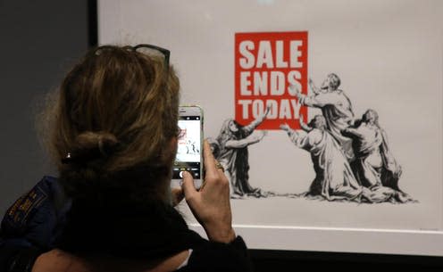 <span class="caption">A visitor enjoys the art of Banksy exhbition at the Mudec Museum in Milan.</span> <span class="attribution"><a class="link " href="http://www.epa.eu/arts-culture-and-entertainment-photos/arts-general-photos/a-visual-protest-the-art-of-banksy-exhibit-photos-54789174" rel="nofollow noopener" target="_blank" data-ylk="slk:EPA-EFE;elm:context_link;itc:0;sec:content-canvas">EPA-EFE</a></span>