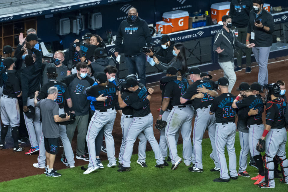 The Miami Marlins celebrate clinching a playoff berth after their win in the 10th inning of a baseball game against the New York Yankees at Yankee Stadium, Friday, Sept. 25, 2020, in New York. (AP Photo/Corey Sipkin)