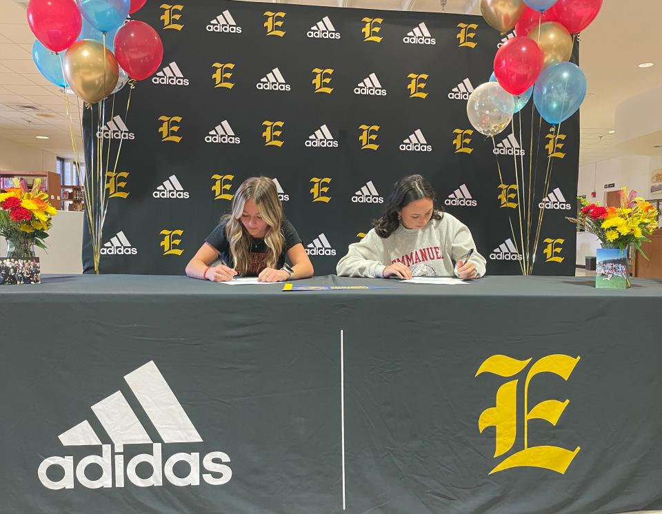 Evans seniors Eva Stawicki (left) and Addison Quinn sign national letters of intent to attend Emmanuel University for women's soccer.