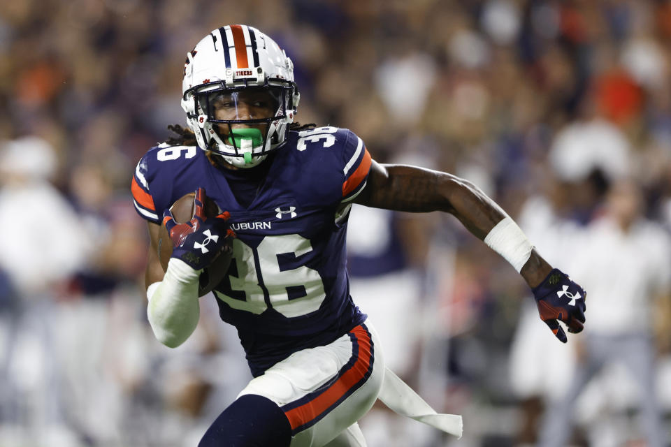 FILE - Auburn cornerback Jaylin Simpson (36) carries the ball after an interception during the first half of an NCAA college football game against Samford Saturday, Sept. 16, 2023, in Auburn, Ala. Simpson has been selected to The Associated Press midseason All-America team, Wednesday, Oct. 18, 2023. (AP Photo/Butch Dill, File)