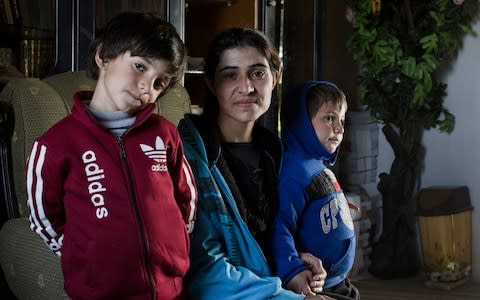 Barfe Khalaf Farho, 26, a Yazidi from Sinjar in Iraq, is photographed withe her two sons Jegar, five and Jan, three, in a Yazidi cultural centre in Hassakeh Province - Credit: Sam Tarling for The Telegraph
