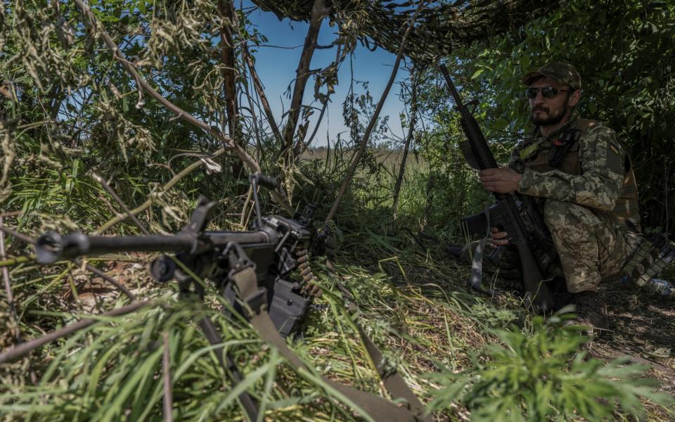 A Ukrainian serviceman looks on near the Ukraine-Russia border in Kharkiv - VIACHESLAV RATYNSKYI/REUTERS