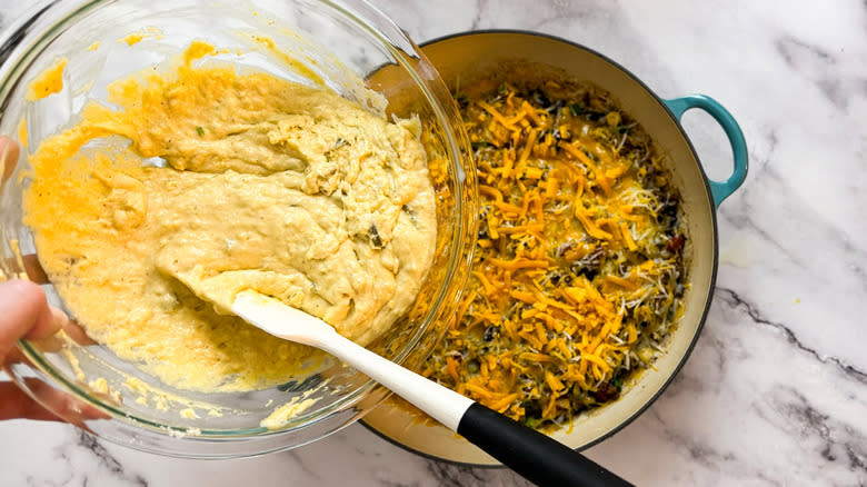 hand putting batter into pot