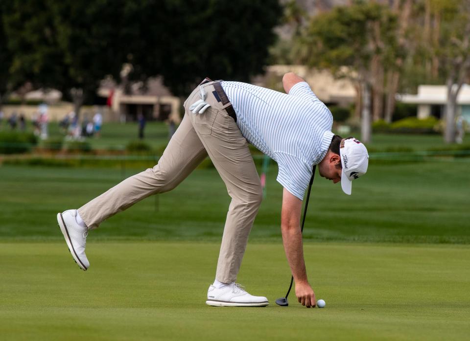 J.T. Poston spots his ball on the first green during Round 2 of The American Express at La Quinta Country Club in La Quinta, Calif., Friday, Jan. 19, 2024.