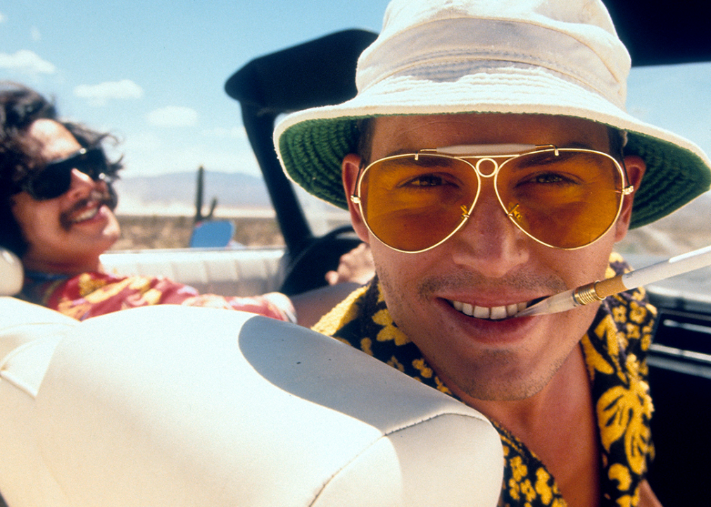 Benicio Del Toro and Johnny Depp in convertible together in a scene from the film 'Fear And Loathing In Las Vegas',