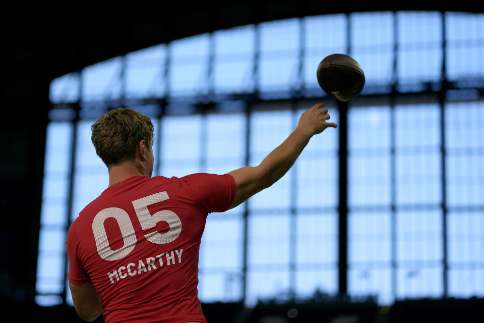 Michigan quarterback J.J. McCarthy passes during the NFL football scouting combine, Saturday, March 2, 2024, in Indianapolis. (AP Photo/Charlie Riedel)