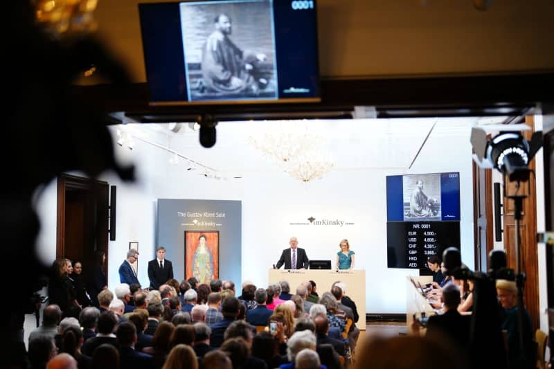 Auctioneer Michael Kovacek announces the sale of the painting "Portrait of Miss Lieser" by Austrian painter Gustav Klimt during an auction. A long-lost portrait of a young woman by Gustav Klimt has been sold for 30 million euros at an auction in Vienna. Eva Manhart/APA/dpa