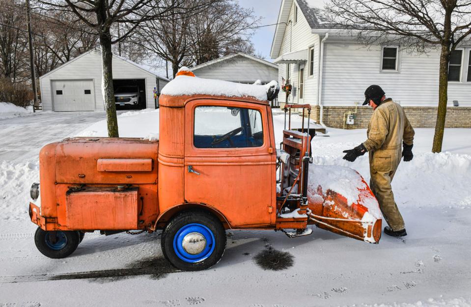 Slim Carlson makes an adjustment on his custom-made snowblower while helping neighbors Monday, Dec. 27, 2021, in St. Cloud. Carlson crafted the machine starting with the cab of a 1936 truck. It features a heated cab and can blow snow about 100 feet in the air. 