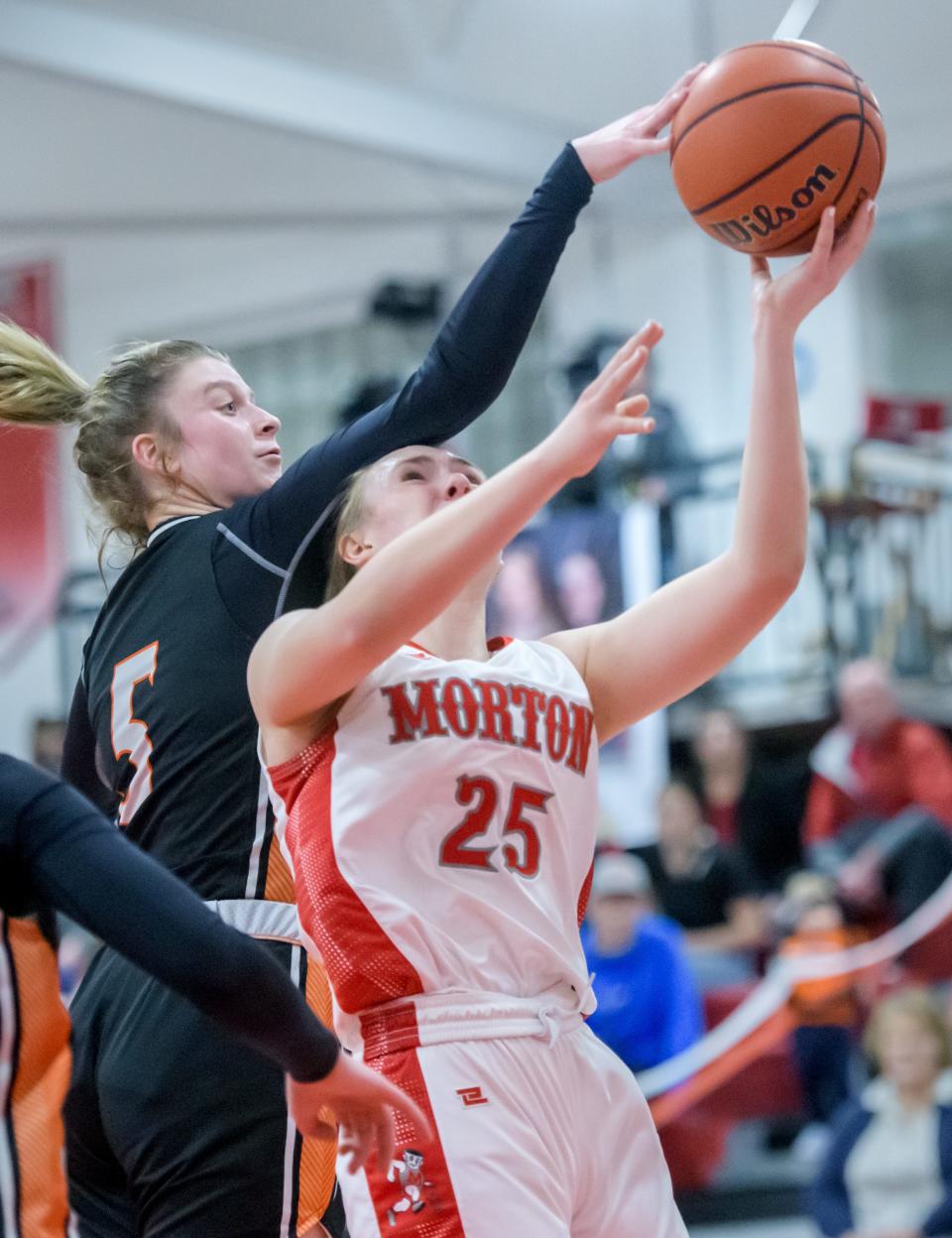 Washington's Becca McDougall (5) blocks a shot by Morton's Ellie VanMeenen in the first half of their Mid-Illini Conference basketball game Tuesday, Feb. 6, 2024 in Morton. The Potters clinched the conference title with a 45-41 victory.