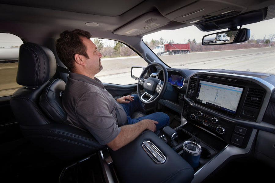 Man using Ford Bluecruise to drive with hands off wheel