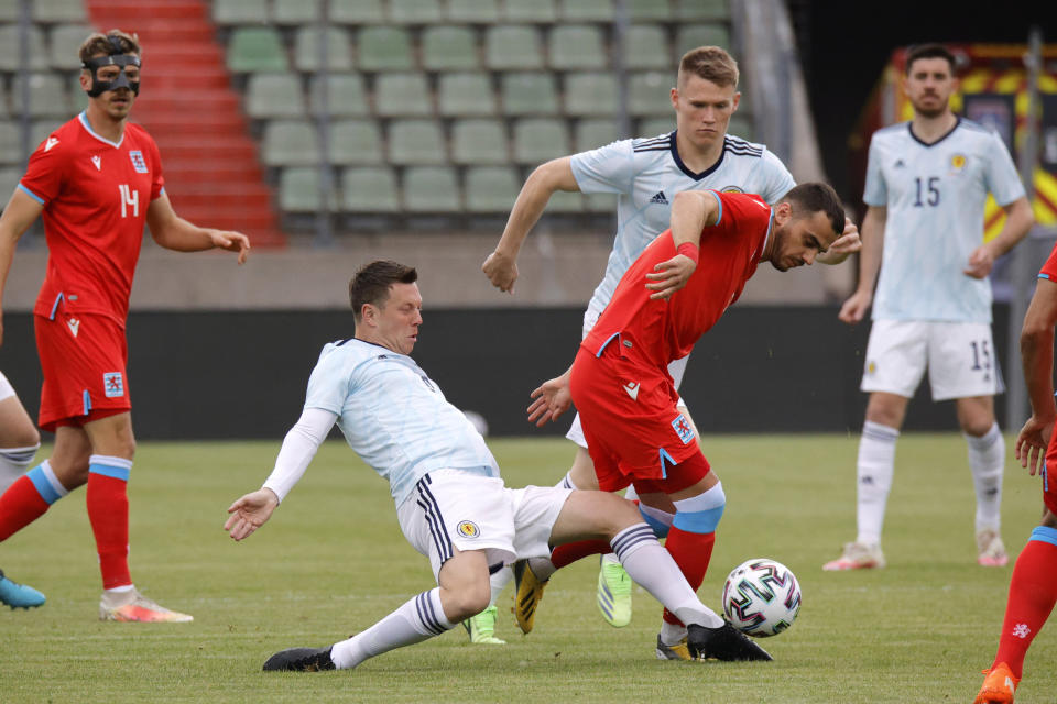 Scotland's Callum McGregor, left, fights for the ball with Luxembourg's Danel Sinani during the international friendly soccer match between Luxembourg and Scotland at the Josy Barthel Stadium in Luxembourg, Sunday, June 6, 2021. (AP Photo/Olivier Matthys)