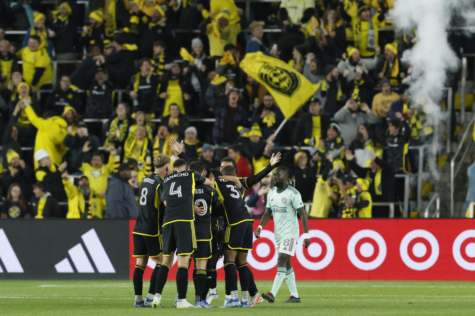 Columbus Crew players celebrate their goal against Atlanta United during the first half of an MLS playoff soccer match, Sunday, Nov. 12, 2023, in Columbus, Ohio. (AP Photo/Jay LaPrete)