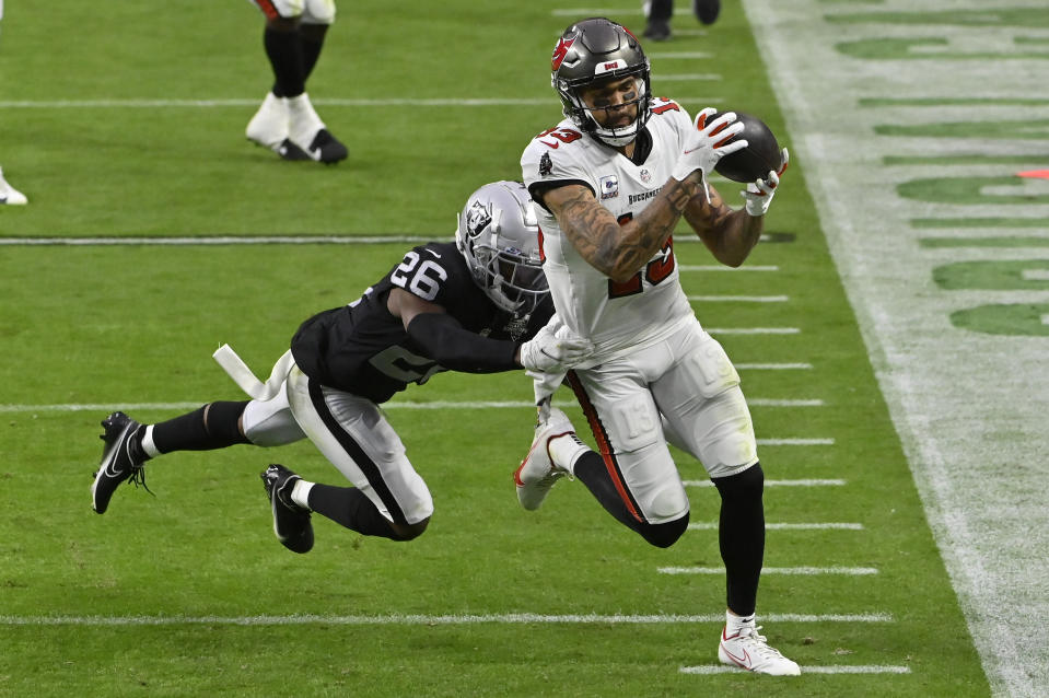 Las Vegas Raiders cornerback Nevin Lawson (26) pushes Tampa Bay Buccaneers wide receiver Mike Evans (13) out of bounds during the second half of an NFL football game, Sunday, Oct. 25, 2020, in Las Vegas. (AP Photo/David Becker)