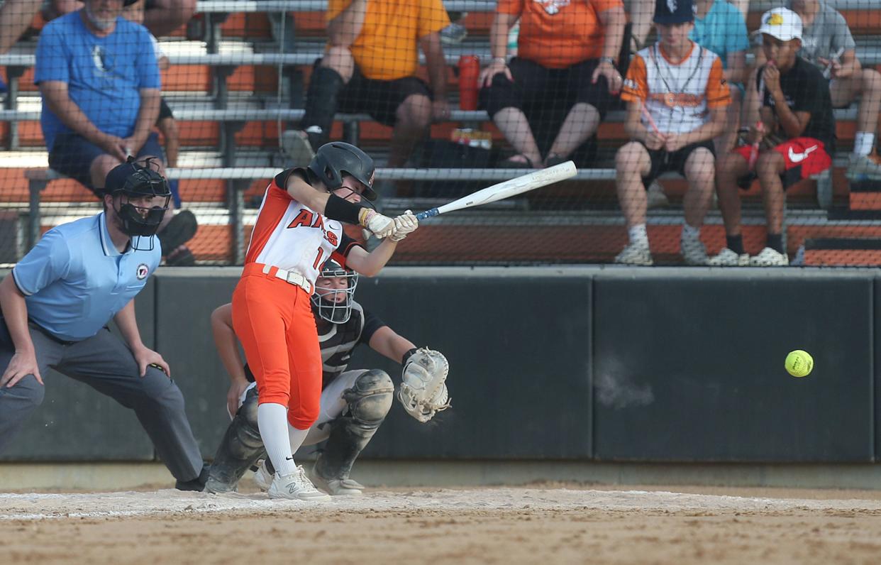 Ames softball player Kaylee Mescher (14) hits the ball for a single against Waukee Northwest during the fourth inning of the Little Cyclones' 9-1 loss to the No. 3 Wolves at the Ames Softball Field on Friday, June 21, 2024, in Ames, Iowa.