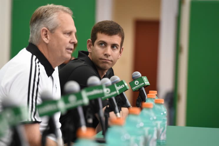 Celtics coach Brad Stevens looks toward team president Danny Ainge during a news conference. The Celtics have some more moves to make after luring Gordon Hayward to Boston. (Getty)