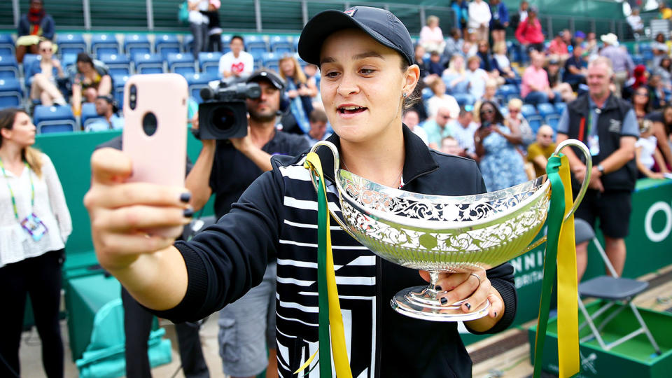 Ashleigh Barty of Australia takes a selfie with the Maud Watson Trophy after victory in her final match of the Nature Valley Classic. (Photo by Jordan Mansfield/Getty Images for LTA)