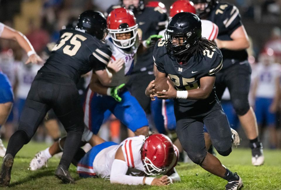 Malik Cobb (25) carries the ball during the Pace vs Milton spring football game at Milton High School on Thursday, May 18, 2023.