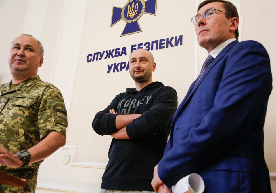 Russian journalist Arkady Babchenko (centre) has shown up at a news conference alive after being reported dead. Photo: AAP