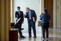 Senate Minority Leader Sen. Chuck Schumer of N.Y. speaks with aides before a meeting with House Speaker Nancy Pelosi of Calif., Treasury Secretary Steven Mnuchin, and White House Chief of Staff Mark Meadows as they continue to negotiate a coronavirus relief package on Capitol Hill in Washington, Tuesday, Aug. 4, 2020. (AP Photo/Andrew Harnik)