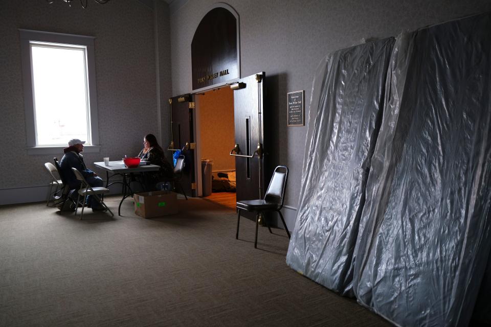 Tess Emory signs in a person Monday, Jan. 30, 2023, at St. Paul's Episcopal Cathedral, which has opened its doors to the homeless for this stretch of extremely cold weather.