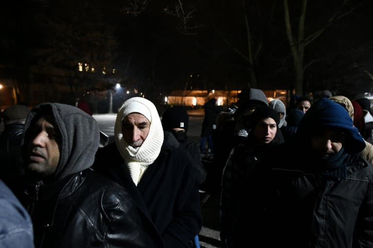 Migrants queue to register at the State Office of Health and Social Affairs centre in Berlin