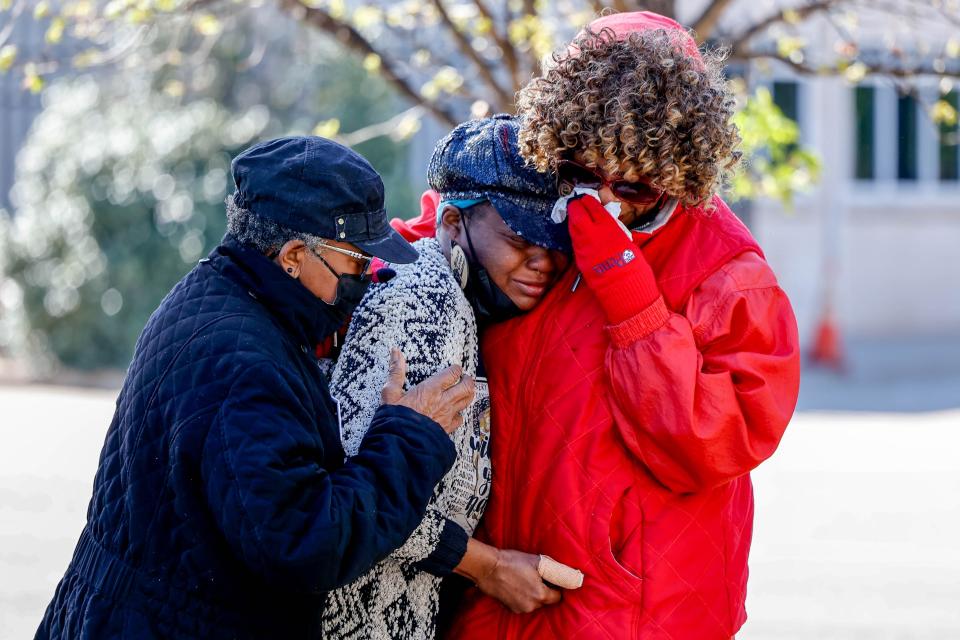 Former Oklahoma Sen. Connie Johnson, right, comforts Ebony Guesby, center, and Guesby’s mother, Helen Coffee, on Thursday as demonstrators stand outside the Governor's Mansion and protest the execution of death row inmate Michael DeWayne Smith.