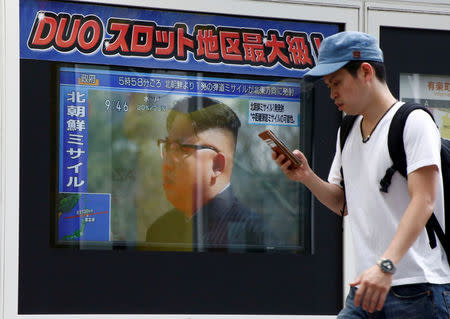 A man walks past a TV set showing North Korea's leader Kim Jong-Un in a news report about North Korea's missile launch in Tokyo, Japan, August 29, 2017. REUTERS/Kim Kyung-Hoon