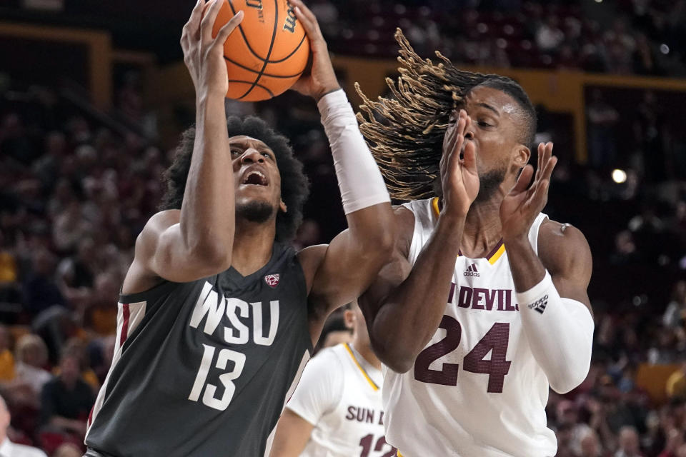 Washington State forward Isaac Jones (13) looks to shoot against Arizona State forward Bryant Selebangue (24) during the first half of an NCAA college basketball game Saturday, Feb. 24, 2024, in Tempe, Ariz. (AP Photo/Darryl Webb)