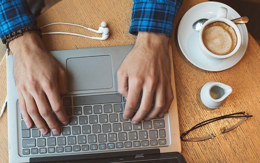 A person typing on a laptop - istock