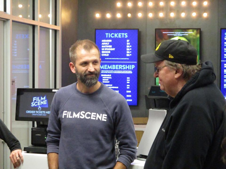 FilmScene founder Andrew Sherburne speaks briefly with director Michael Moore following the filmmaker's visit to Iowa City just before the 2020 caucuses on Thursday, Jan. 30.